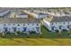 Aerial view showcasing a row of townhouses near a lake at 4858 Tribute Trl, Kissimmee, FL 34746