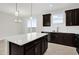 Modern kitchen with dark cabinets and quartz countertops at 4858 Tribute Trl, Kissimmee, FL 34746