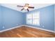 Bedroom with light blue walls and hardwood floors at 4860 Conway Rd # 56, Orlando, FL 32812