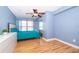 Bedroom with light blue walls, hardwood floors, and ceiling fan at 4860 Conway Rd # 56, Orlando, FL 32812