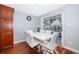 Dining area with white table and chairs near sliding glass doors at 4860 Conway Rd # 56, Orlando, FL 32812