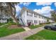 Light blue building with grey stairs and landscaping; ample parking is visible at 4860 Conway Rd # 56, Orlando, FL 32812