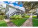 Two-story building with grey stairs and balconies. Landscaped grounds with walkways at 4860 Conway Rd # 56, Orlando, FL 32812