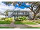 Two-story building with grey stairs and balconies, surrounded by lush landscaping at 4860 Conway Rd # 56, Orlando, FL 32812