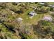 Aerial view showing home, additional structures and a nearby creek at 4950 Nova Ave, St Cloud, FL 34773