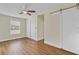 Bright bedroom with wood floors, ceiling fan, and sliding door closet at 4950 Nova Ave, St Cloud, FL 34773