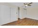 Bedroom with ceiling fan, double door closet, and wood-look floors at 4950 Nova Ave, St Cloud, FL 34773