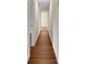 Long hallway with wood flooring and neutral walls at 4950 Nova Ave, St Cloud, FL 34773