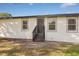 Newly renovated home exterior featuring a modern front door and stylish gray accents at 4950 Nova Ave, St Cloud, FL 34773