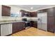 Modern kitchen with dark wood cabinets and stainless steel appliances at 4950 Nova Ave, St Cloud, FL 34773
