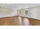 Bright living room featuring wood-look flooring and large windows at 4950 Nova Ave, St Cloud, FL 34773