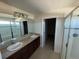Primary bathroom with double vanity and a shower at 640 Spanish Pine Rd, Davenport, FL 33837