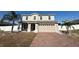Two-story house with a brick driveway and a landscaped lawn at 640 Spanish Pine Rd, Davenport, FL 33837
