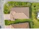 Top-down aerial view of a house with brown roof and neatly landscaped lawn at 681 San Joaquin Rd, Poinciana, FL 34759