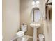 Powder room with pedestal sink and oval mirror at 681 San Joaquin Rd, Poinciana, FL 34759