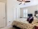 Comfortable bedroom with a floral comforter and ceiling fan at 681 San Joaquin Rd, Poinciana, FL 34759