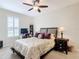 Bright bedroom with a floral comforter and ceiling fan at 681 San Joaquin Rd, Poinciana, FL 34759