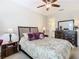 Charming bedroom with a floral comforter and ceiling fan at 681 San Joaquin Rd, Poinciana, FL 34759