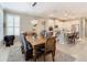 Spacious dining area with a large wood table and wicker chairs near kitchen at 681 San Joaquin Rd, Poinciana, FL 34759