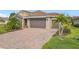 Brick paver driveway leading to a two-car garage at 681 San Joaquin Rd, Poinciana, FL 34759