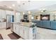Open kitchen features stainless steel appliances and an island that overlooks the living room at 681 San Joaquin Rd, Poinciana, FL 34759