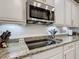 Kitchen features granite countertops and a modern glass top stove at 681 San Joaquin Rd, Poinciana, FL 34759
