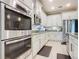 Well-equipped kitchen features stainless steel appliances and white cabinetry at 681 San Joaquin Rd, Poinciana, FL 34759