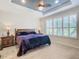 Main bedroom with a king-size bed,plantation shutters and ceiling fan at 681 San Joaquin Rd, Poinciana, FL 34759