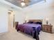 Spacious main bedroom with a king-size bed and wood nightstands at 681 San Joaquin Rd, Poinciana, FL 34759