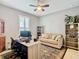 Home office with a desk, couch, and built-in shelving at 681 San Joaquin Rd, Poinciana, FL 34759