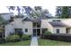 Tan two-story townhouse with a landscaped yard and walkway at 72 Aspen Dr, Haines City, FL 33844