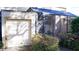 Attached garage with storage and flowering bushes at 72 Aspen Dr, Haines City, FL 33844
