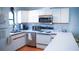 White kitchen with stainless steel appliances and an eat-in counter at 72 Aspen Dr, Haines City, FL 33844