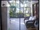 Relaxing screened patio with wicker furniture and view of backyard at 72 Aspen Dr, Haines City, FL 33844