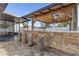 Outdoor kitchen with stone counter, built-in grill, and tiki bar at 8 Catalina Ct, Kissimmee, FL 34758