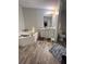 Bathroom with corner bathtub and wood-look flooring at 8185 County Road 109, Lady Lake, FL 32159