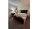 Bedroom with carpeted floor and floral bedding at 8185 County Road 109, Lady Lake, FL 32159