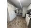 Kitchen with white cabinets and wood-look flooring at 8185 County Road 109, Lady Lake, FL 32159