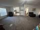 Living room with carpet and view into kitchen at 8185 County Road 109, Lady Lake, FL 32159