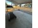 Screened porch with concrete floor and treadmill at 8185 County Road 109, Lady Lake, FL 32159