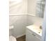 Clean bathroom with white vanity and tiled walls at 916 S Park Ct, Kissimmee, FL 34741