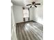 Bright bedroom with wood-look floors and ceiling fan at 916 S Park Ct, Kissimmee, FL 34741