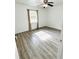 Well lit bedroom with wood-look floors and window at 916 S Park Ct, Kissimmee, FL 34741