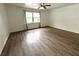 Spacious bedroom with wood-look floors and large window at 916 S Park Ct, Kissimmee, FL 34741