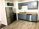 Modern kitchen featuring blue cabinets and stainless steel appliances at 916 S Park Ct, Kissimmee, FL 34741