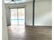 Bright living room with pool view and wood-look floors at 916 S Park Ct, Kissimmee, FL 34741