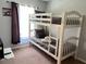 Bright bedroom with a bunk bed, window, and neutral walls at 922 Sandy Ridge Drive Dr, Davenport, FL 33896