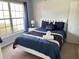 Bright bedroom with a comfortable bed and plenty of natural light at 922 Sandy Ridge Drive Dr, Davenport, FL 33896