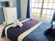 Relaxing bedroom with large window and comfortable bedding at 922 Sandy Ridge Drive Dr, Davenport, FL 33896