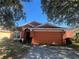 Front view of a charming one-story house with a spacious driveway at 922 Sandy Ridge Drive Dr, Davenport, FL 33896